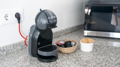 a black coffee maker on a counter next to a microwave at Cal Perot Apartamento turístico en Les Borges Blanques in Les Borges Blanques 