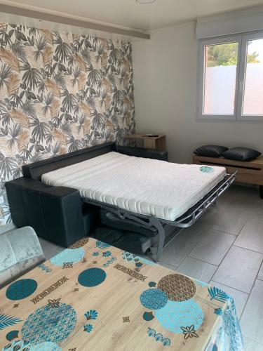 a bed in a room with a mattress at La Vague in Gravelines