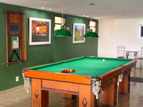 a pool table with balls on it in a room at Stratus Centro Hotel in Volta Redonda