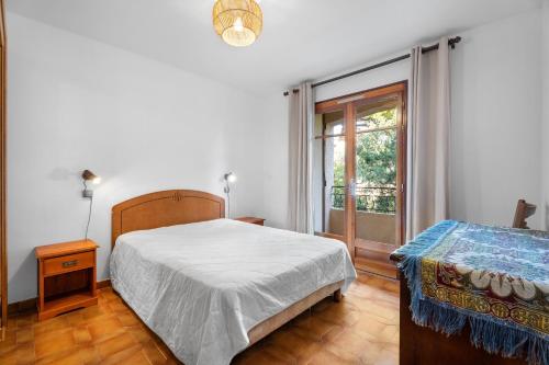 Appartement Tout Confort في ليه ليكيه: غرفة نوم بسرير كبير ونافذة