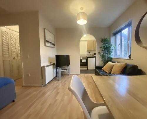 a living room with a couch and a table at Studio Apartment in Bracknell in Bracknell