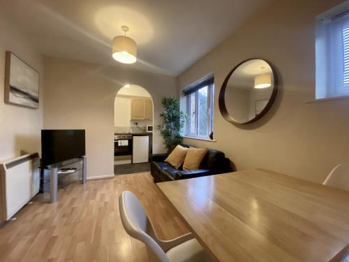 a living room with a wooden table and a couch at Studio Apartment in Bracknell in Bracknell