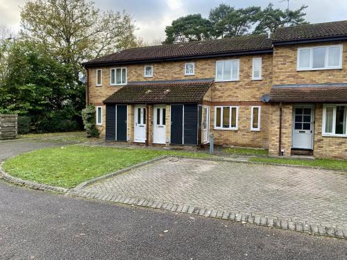 a brick house with a driveway in front of it at Studio Apartment in Bracknell in Bracknell