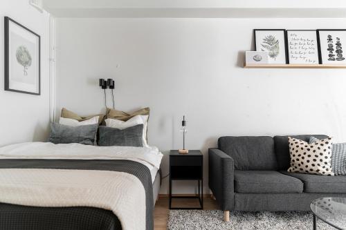 a bedroom with a bed and a chair at Stylish, 450 m walk to the Estonian ferry, Free parking and balcony in Helsinki