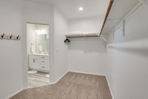 a white room with a staircase with a sink and a mirror at Work, Explore and Unwind Lovely Permian Basin Home in Odessa