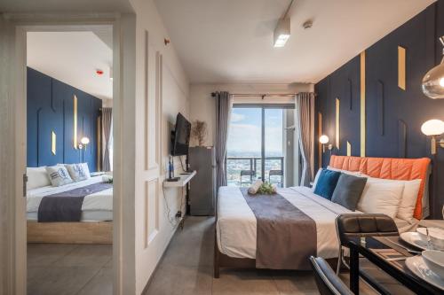 Postel nebo postele na pokoji v ubytování Unixx Pattaya by Chanakan