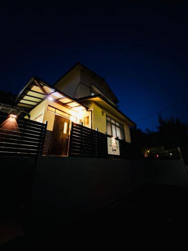 a house with lights on the front of it at night at アンペ別邸 別府鉄輪 Ampe Villa Beppu kannawa in Beppu