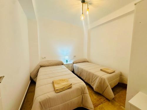 Postel nebo postele na pokoji v ubytování Las Arenas del Coliseo