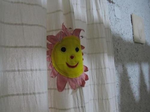 a smiley face face pinned to a curtain at Lieber Hiemell 2 in Betina