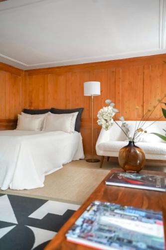 a bedroom with a white bed and a white couch at Charming Historical Apartment in Zurich City Center Oldtown in Zurich