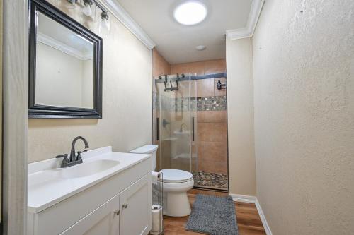 a bathroom with a sink and a toilet and a shower at Three Oaks in Mena