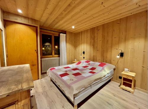 a bedroom with a bed in a wooden room at Résidences Delavay La Cordée in Les Gets