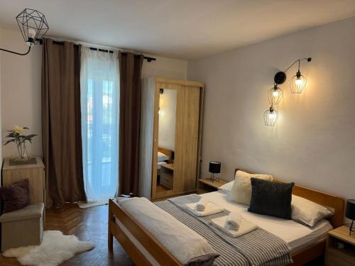 a bedroom with a bed and a mirror at Apartments Solis, 50 m from the sea - Jakišnica in Jakišnica