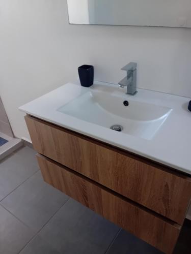 a bathroom with a white sink in a room at sci careffour dugomier in Le Moule