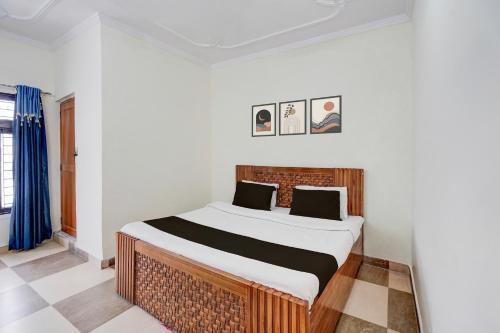 um quarto com uma cama grande em um quarto em Hotel O KK em Haldwani-cum-Kathgodam