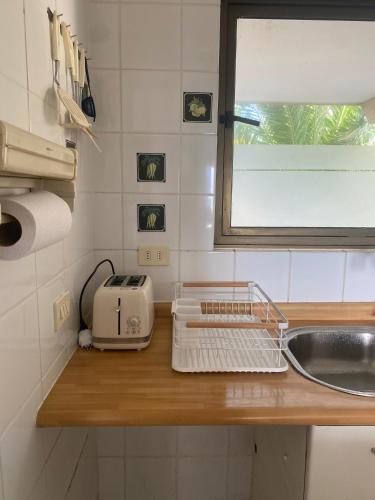 a kitchen counter with a sink and a toaster at San Alfonso del Mar, Vela Mayor in Algarrobo
