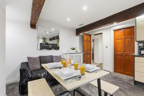 a living room with a table and a couch at The Snug- Ideal for Work & Leisure Stays in Bury