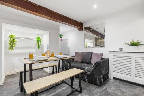 a living room with a table and a couch at The Snug in Bury