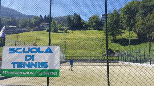 a sign on a fence at a baseball field at Santa Elisabetta Apartment in Caspoggio