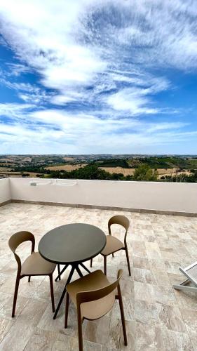 a table and chairs sitting on top of a balcony at La Principessa Nera B&B in Ostra