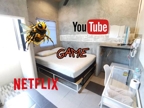 aumblebee on a bed in a room with the words you tube game at Hive28 in Bang Kapi