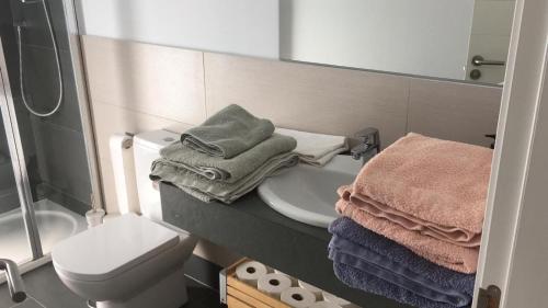 a bathroom with a sink and a toilet and a mirror at Villa Rompido in El Rompido