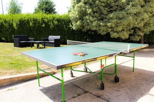 a ping pong table with a racket on top of it at Ty Bénodet - Maison de vacances in Bénodet
