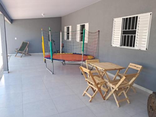 a room with a table and chairs and a playground at Meu Refúgio in Boituva