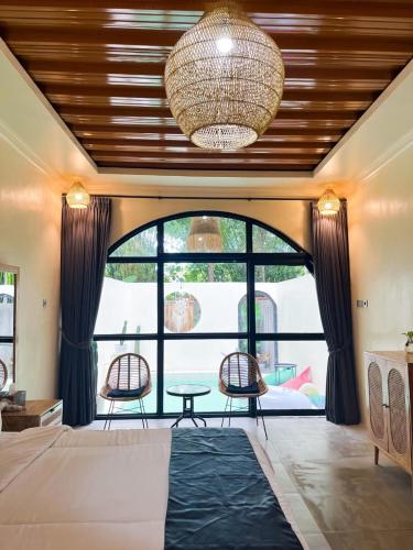 a bedroom with a large bed and a large window at Lasakha Villa in Bantul