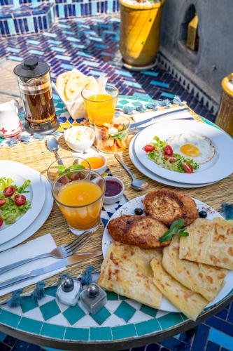 a table with plates of food on top at Riad Serendip in Marrakech