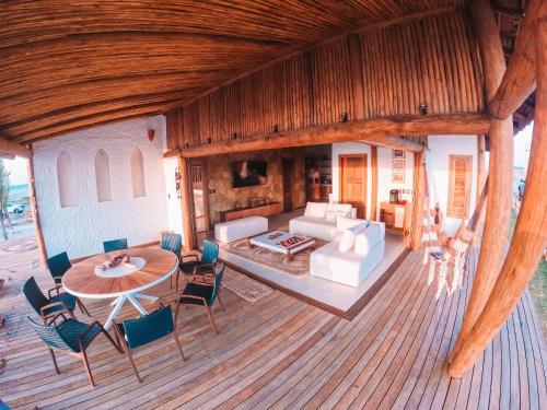 an aerial view of a living room with a table and chairs at Villa Caraúbas in Camocim