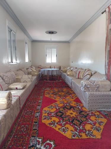 a large living room with couches and a rug at Berber Family 