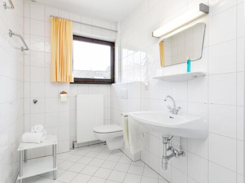 a white bathroom with a toilet and a sink at Brixen Alpin Living Top 8 in Brixen im Thale