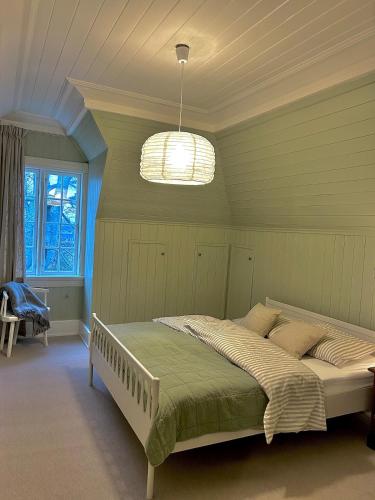 a bedroom with a large bed in a room at Historic villa with large garden in Stord