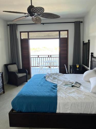 a bedroom with a large bed with a ceiling fan at Lavista Antigua in Bats Cave