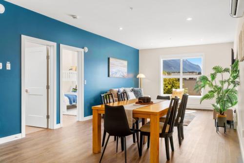 a dining room with blue walls and a table and chairs at Stylish 2BR Golden Getaway with BBQ and Stunning Views in Golden