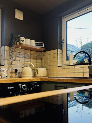 a kitchen with a counter and a sink and a window at Modern 3BR Smart Home in Peterhead