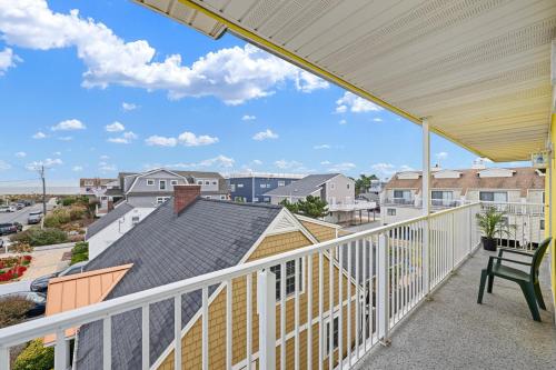 a balcony with a bench and a view of the city at SURFRIDER Dewey Beach Ocean Block in Dewey Beach