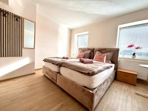 a bedroom with a bed and a window at kERVANHOF an der Donau in Kleinpöchlarn