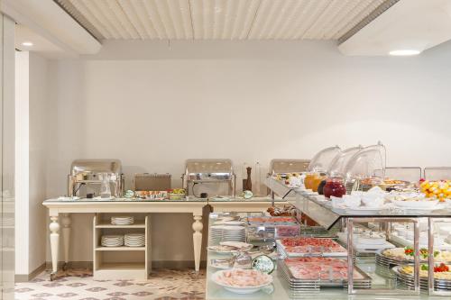a buffet with many different types of food on display at Olivi Hotel & Natural Spa in Sirmione
