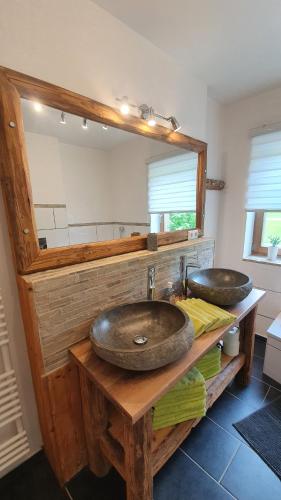 a bathroom with two sinks and a mirror at Chalet Steinplatte in Reit im Winkl