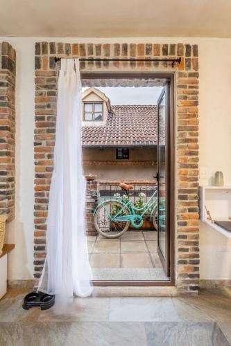 a wedding dress in front of a window at Cipressi Lofts Val'Quirico in Santeagueda