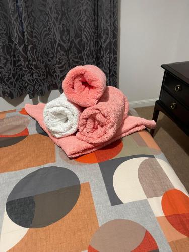 a pair of towels sitting on top of a bed at Executive 1 Bed Lovely Apartment in Aberdeen