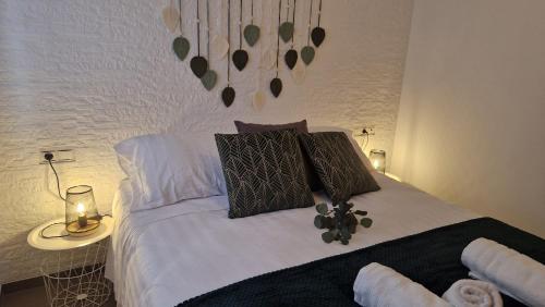 a bedroom with a bed with white sheets and pillows at Lo Pateret in Corbera