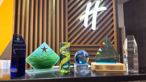 a table topped with different types of glass awards at Holiday Inn Bournemouth by IHG in Bournemouth
