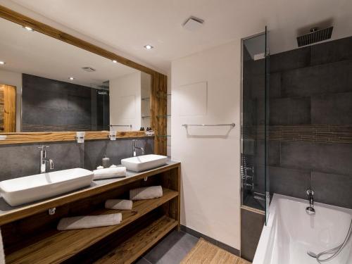 a bathroom with two sinks and a shower at Appartement de standing à Courchevel avec vue, proche des pistes, parking inclus - FR-1-575-59 in Courchevel