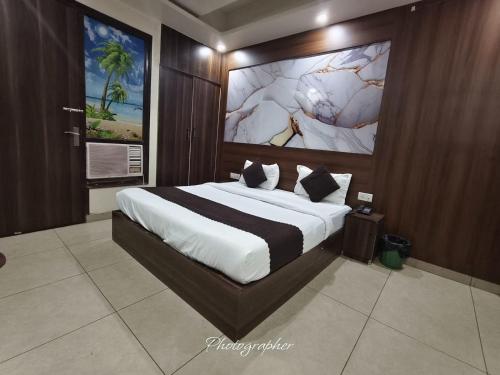 a bedroom with a large bed in a room at Hotel Blu Bird in New Delhi
