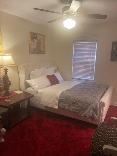 a bedroom with a bed and a ceiling fan at Splendid Room in House 10 mins to Airport in Saint Louis