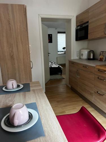 a kitchen with a table with a pink tea pot on it at Apartment im Grünen -Garden in Chemnitz