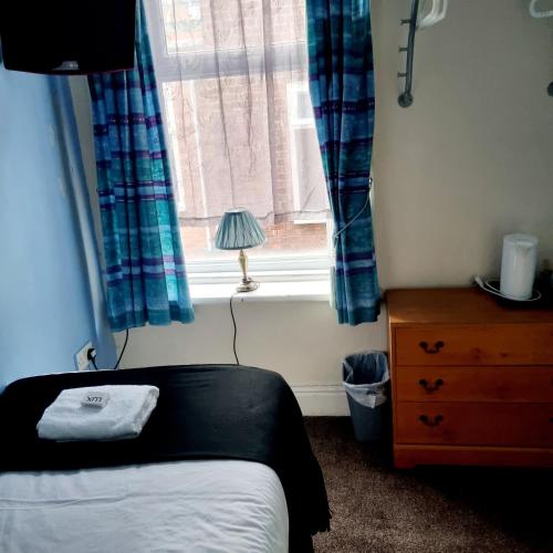 a bedroom with a bed and a window at The New Osterley Hotel in Blackpool